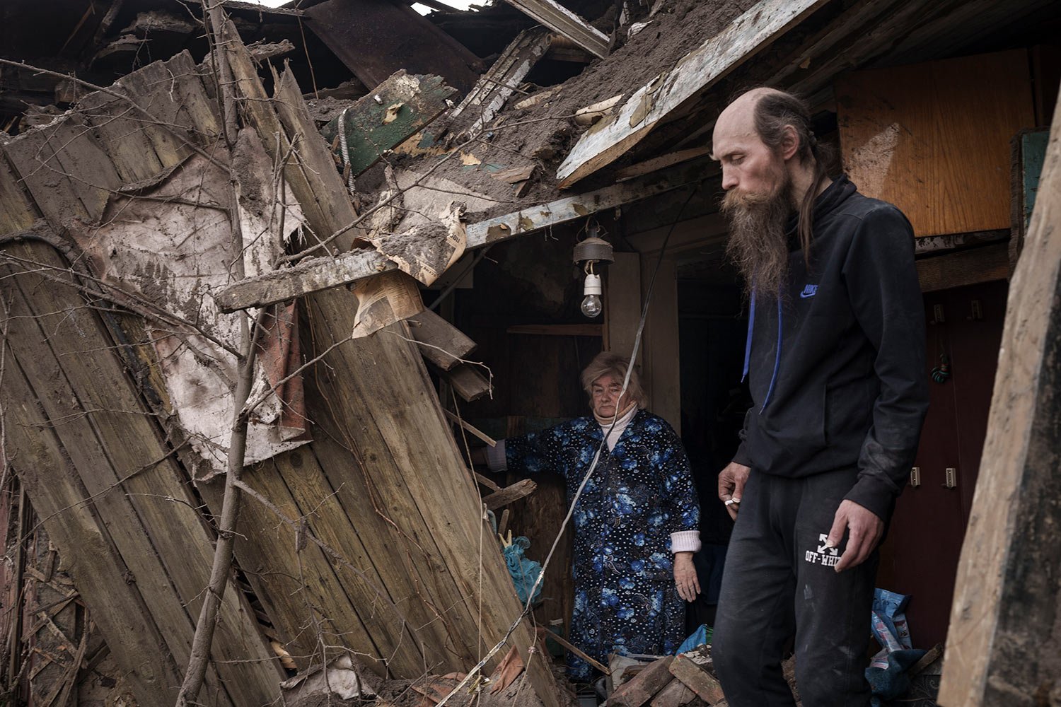  Oleg Mezhiritsky, right, and his mother Lidiya Mezhiritska, stand outside their house, damaged after a Russian attack in Kharkiv, Ukraine, Friday, April 8, 2022. (AP Photo/Felipe Dana) 