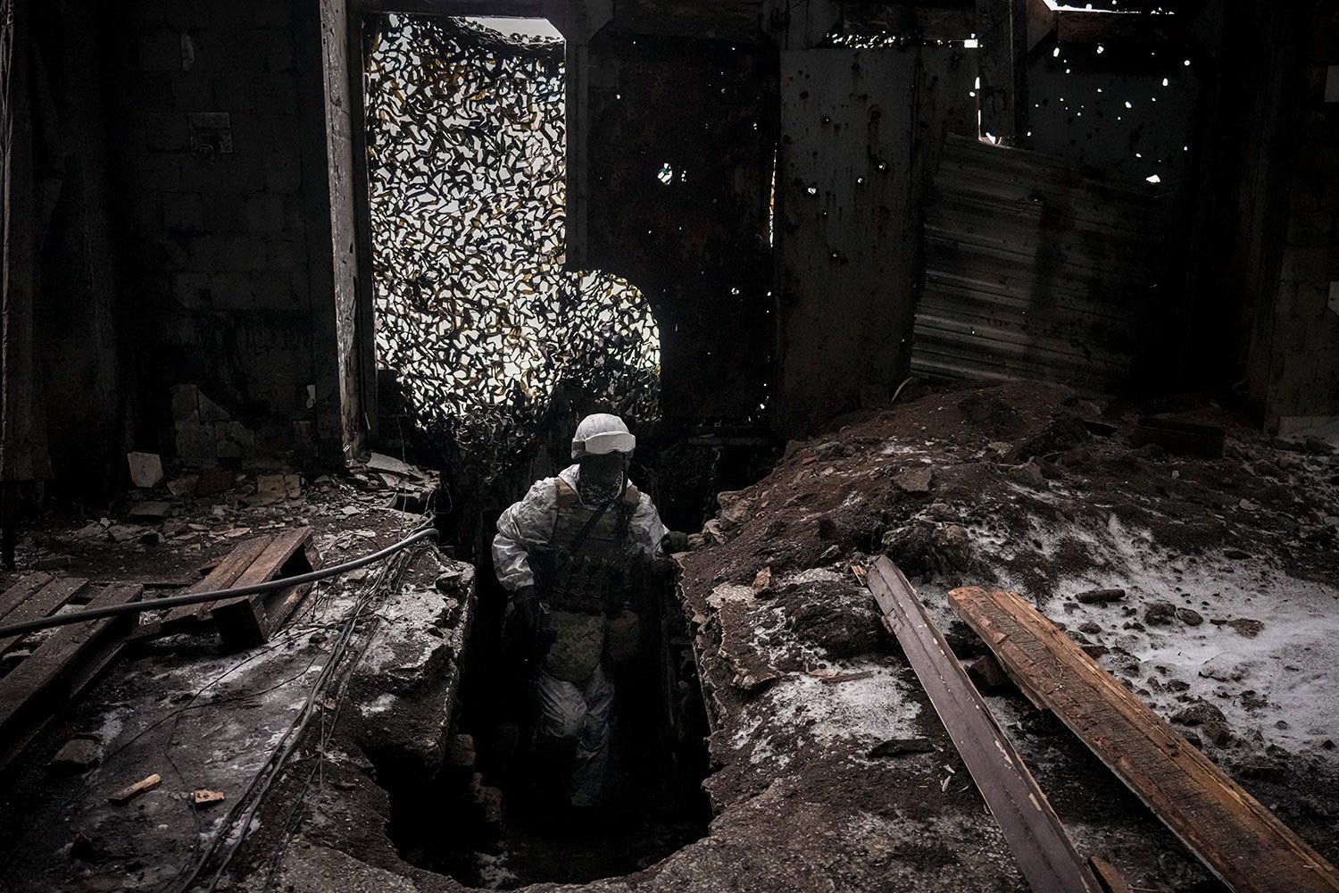  Ukrainian serviceman Ivan Skuratovskyi patrols the ruins of an industrial area, now a frontline position outside Avdiivka, Donetsk region, eastern Ukraine, Friday, Feb. 4, 2022. (AP Photo/Vadim Ghirda) 