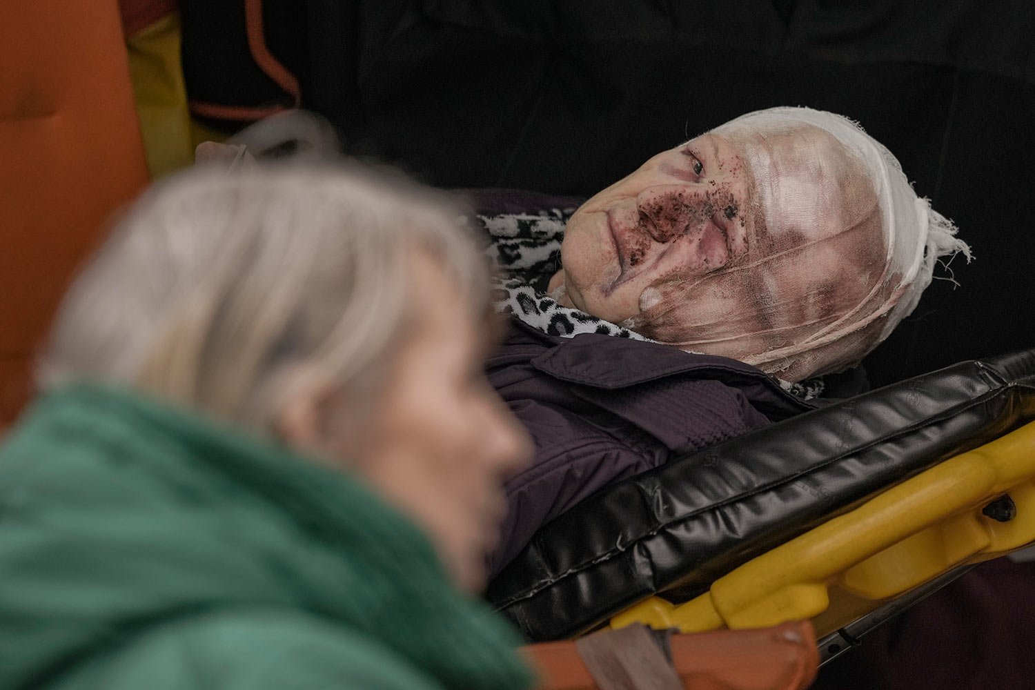  An injured woman evacuated from Irpin lies on a stretcher in an ambulance on the outskirts of Kyiv, Ukraine, Saturday, March 26, 2022. (AP Photo/Vadim Ghirda) 