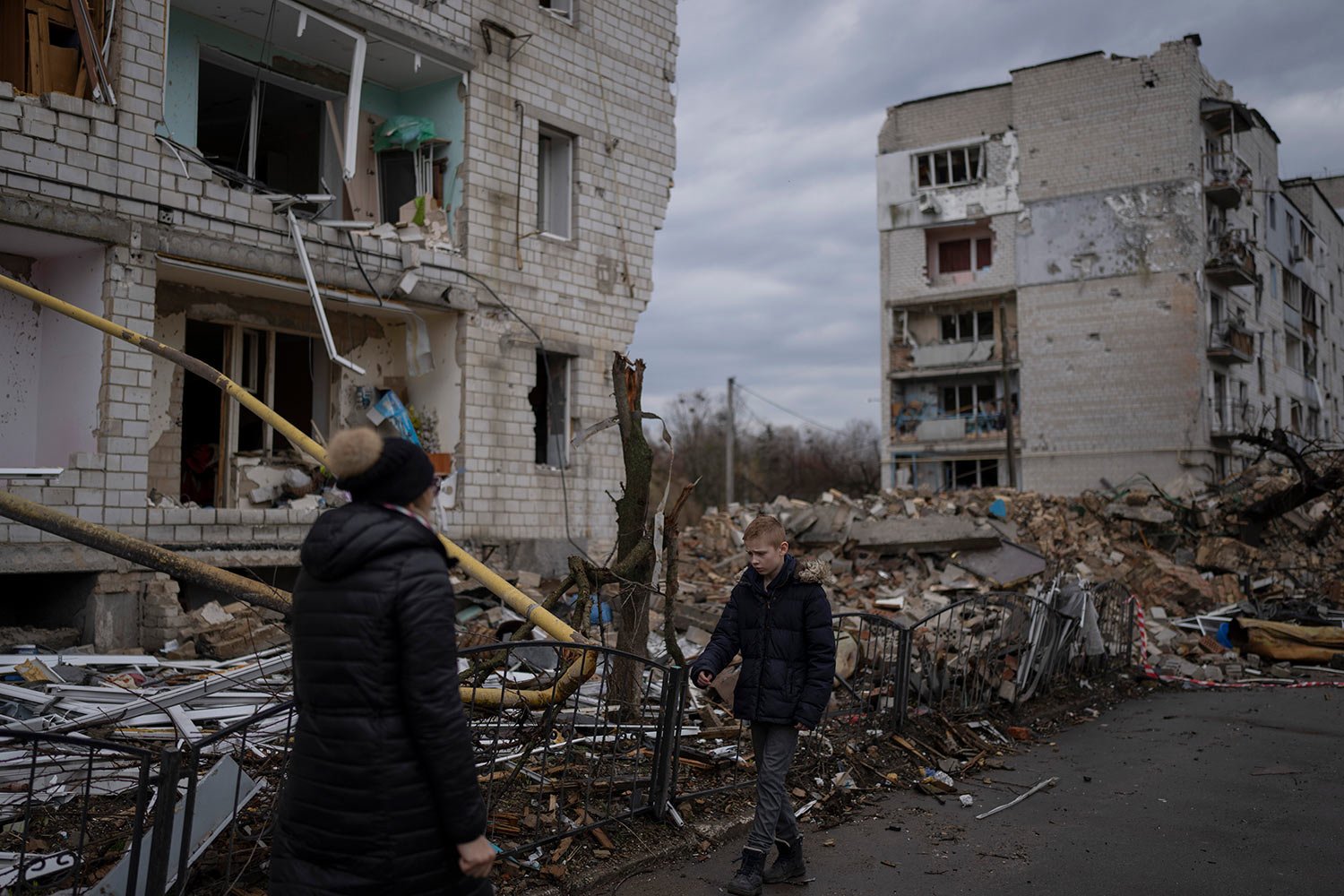  A boy is searching for his cat as he walks outside a destroyed apartment building in the town of Borodyanka, Ukraine, on Saturday, April 9, 2022. (AP Photo/Petros Giannakouris) 