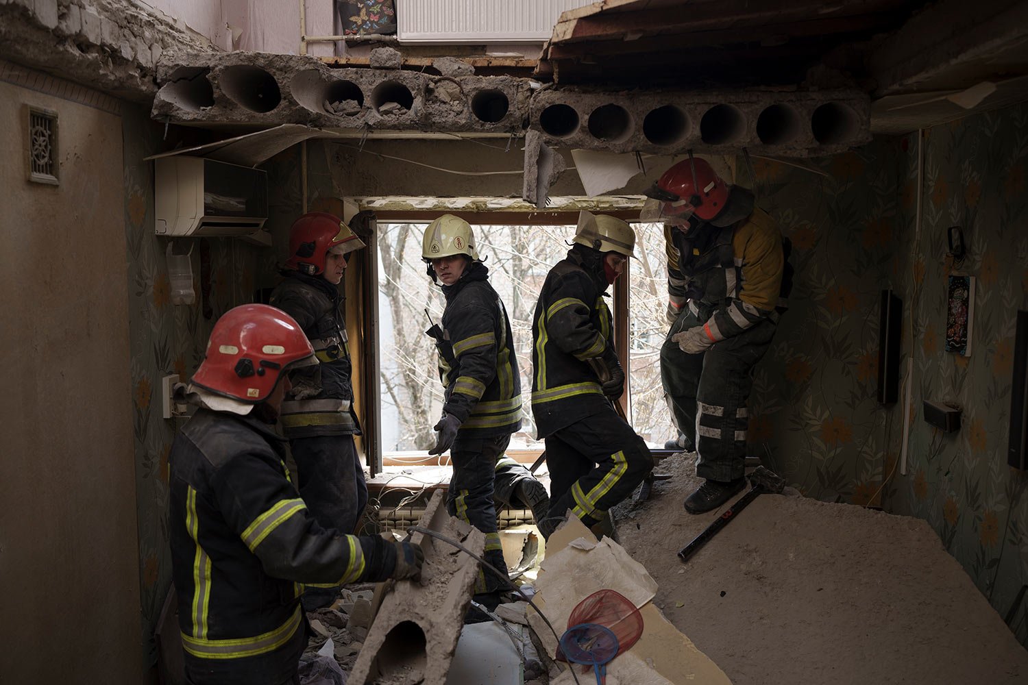  Firefighters work to secure a residential building previously damaged by a Russian attack in Kharkiv, Ukraine, Saturday, April 9, 2022. (AP Photo/Felipe Dana) 