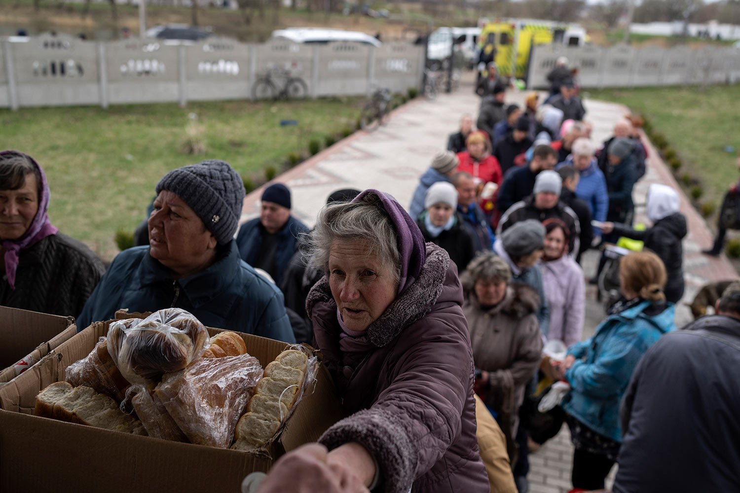  People receive food from a church in the town of Borodyanka, about 40 miles northwest of Kyiv, Ukraine, on Sunday, April 10, 2022. (AP Photo/Petros Giannakouris) 