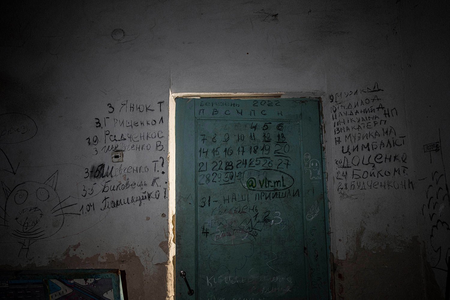  Writing can be seen on a wall and a door in the basement of a school in Yahidne, near Chernihiv, Ukraine, Tuesday, April 12, 2022. Residents say more than 300 people were trapped for weeks by Russian occupiers in  the basement of the school in Yahid