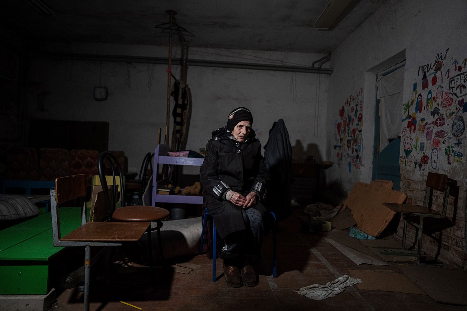  Valentina Saroyan sits in the basement of a school in Yahidne, near Chernihiv, Ukraine, Tuesday, April 12, 2022. Residents say more than 300 people were trapped for weeks by Russian occupiers in the basement of the school in Yahidne.  (AP Photo/Evge