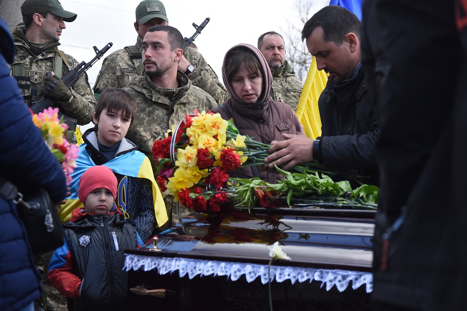  Relatives and friends stand by the coffins of Ukrainian servicemen Yuri Filyuk, 49, and Oleksander Tkachenko, 33, during a funeral ceremony in a village of Oleksandrivka, Odesa region, Ukraine, Tuesday, April 12, 2022. According to Ukrainian service