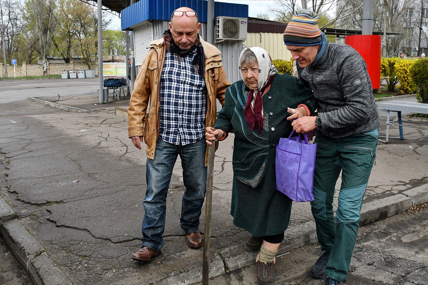  Men help Maria Dyachenko, 83, to board a transport during evacuation of civilians in Kramatorsk, Ukraine, Tuesday, April 12, 2022. Maria left the village of Dovhenke, south of Izyum, Kharkiv region. (AP Photo/Andriy Andriyenko) 