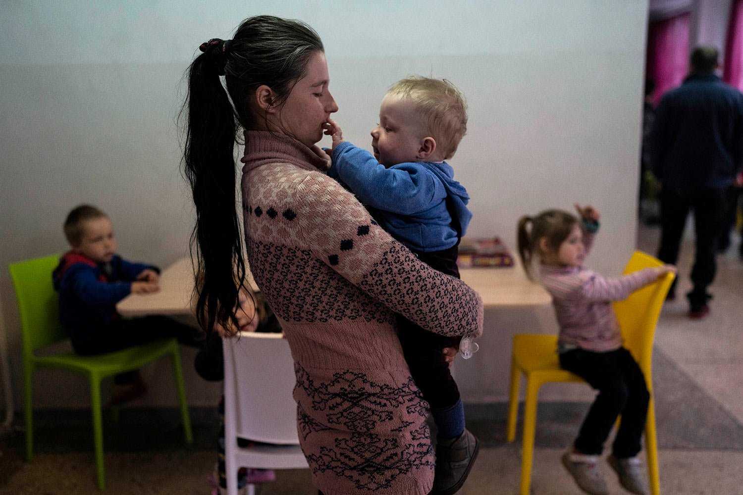  Marta Fedorova holds her baby boy as her son Volodymir 6, and her daughter Violetta 5, right, sit inside a school that is being used as a shelter for people who fled the war, in Dnipro city, Ukraine, on Tuesday, April 12, 2022. Marta Fedorova with h