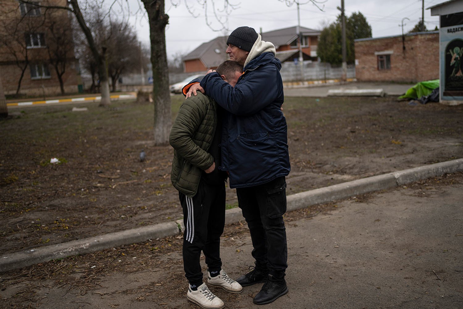  The father and a friend of Anatoliy Kolesnikov, 30, who was killed by Russian soldiers in his car trying to evacuate from Irpin, mourns his death while waiting outside the morgue in Bucha, in the outskirts of Kyiv, Ukraine, Wednesday , April 13, 202