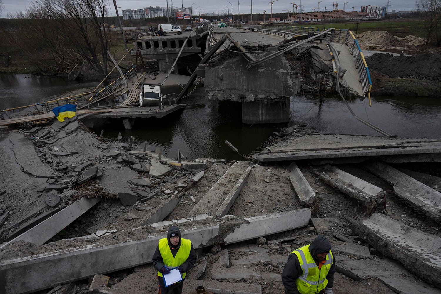  Engineers inspect the state of destruction of the bridge that connects Kyiv with Irpin, Ukraine, Wednesday, April 13, 2022. (AP Photo/Rodrigo Abd) 