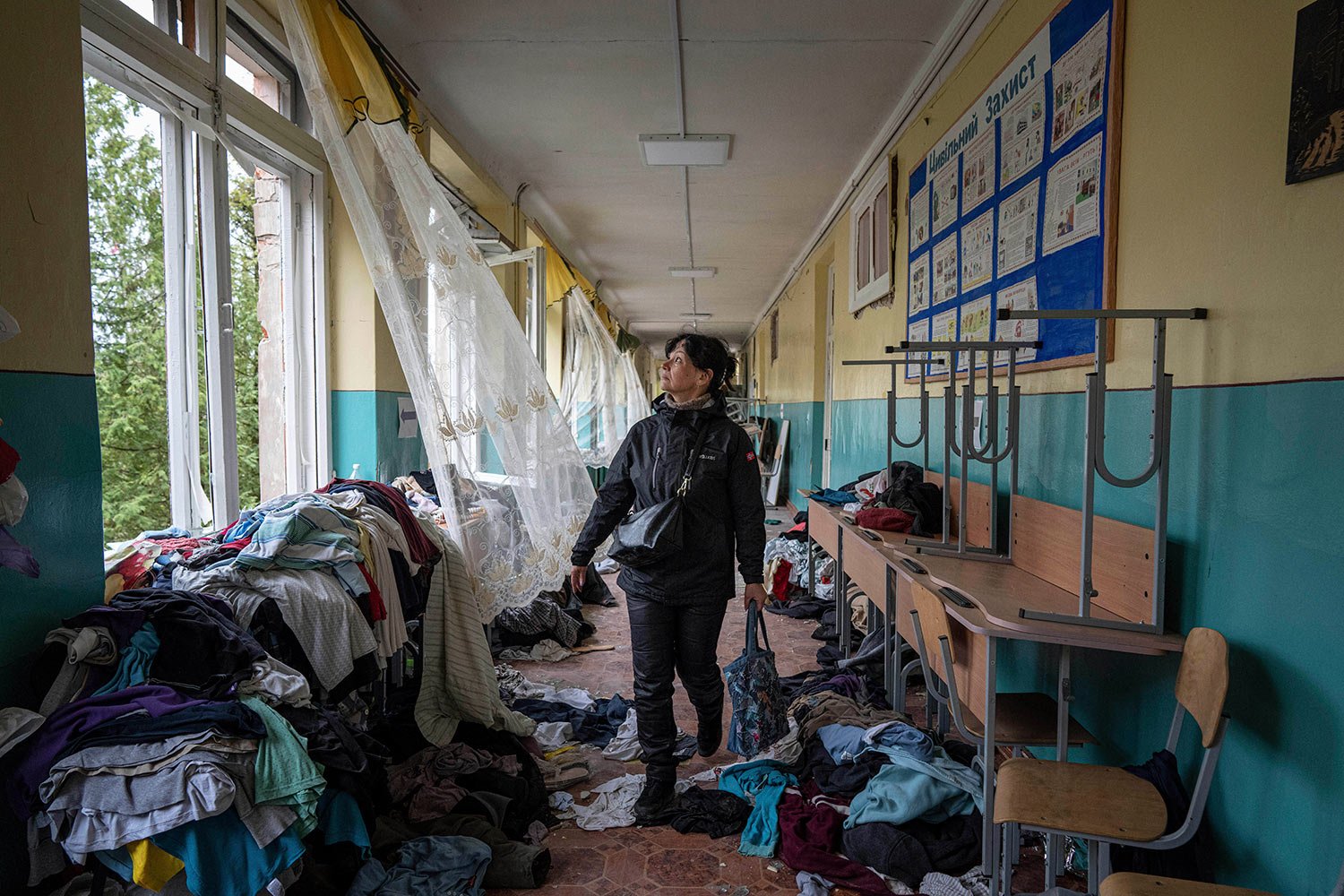  A school director Iryna Homenko walks in the hall of the school damaged by an airstrike from Russian forces in Chernihiv, Ukraine, Wednesday, April 13, 2022. (AP Photo/Evgeniy Maloletka) 