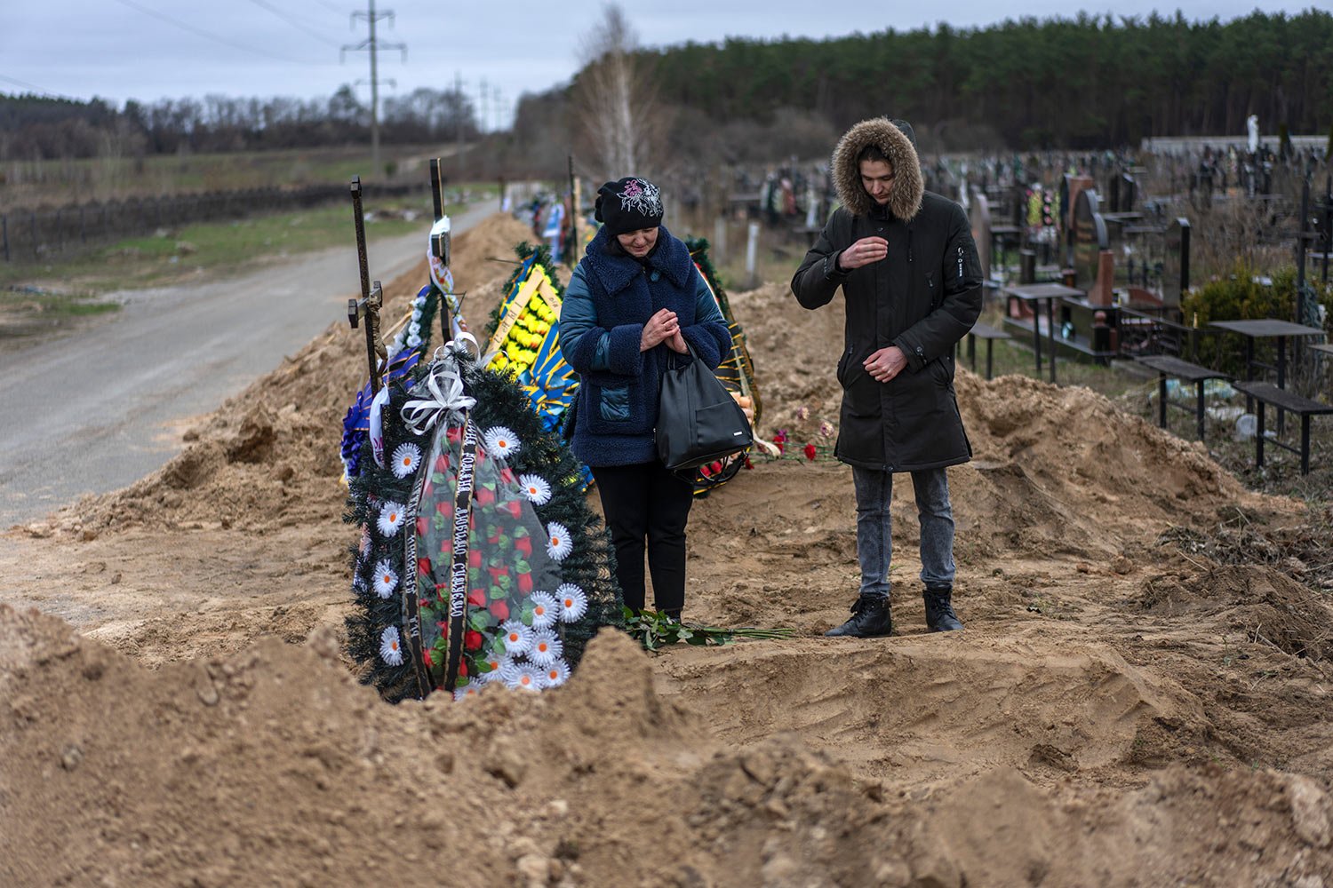  Natalya Verbova, 49, and her son Roman Verbovyi, 23, attend the funeral of her husband Andriy Verbovyi, 55, who was killed by Russian soldiers while in the territorial defense in Bucha on the outskirts of Kyiv, Ukraine, Wednesday , April 13, 2022. (