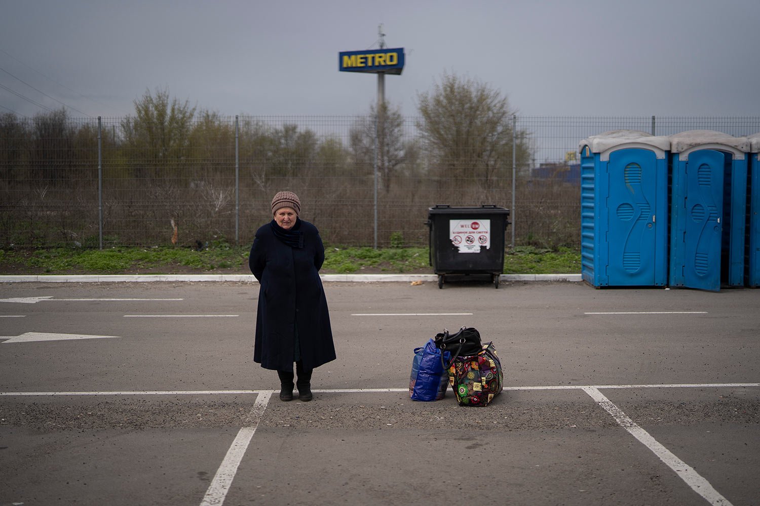  Helena stands next to her belongings after arriving from Mariupol at a refugee center in Zaporizhzhia, Ukraine, Thursday, April 21, 2022, after fleeing from the Russian attacks. (AP Photo/Leo Correa) 