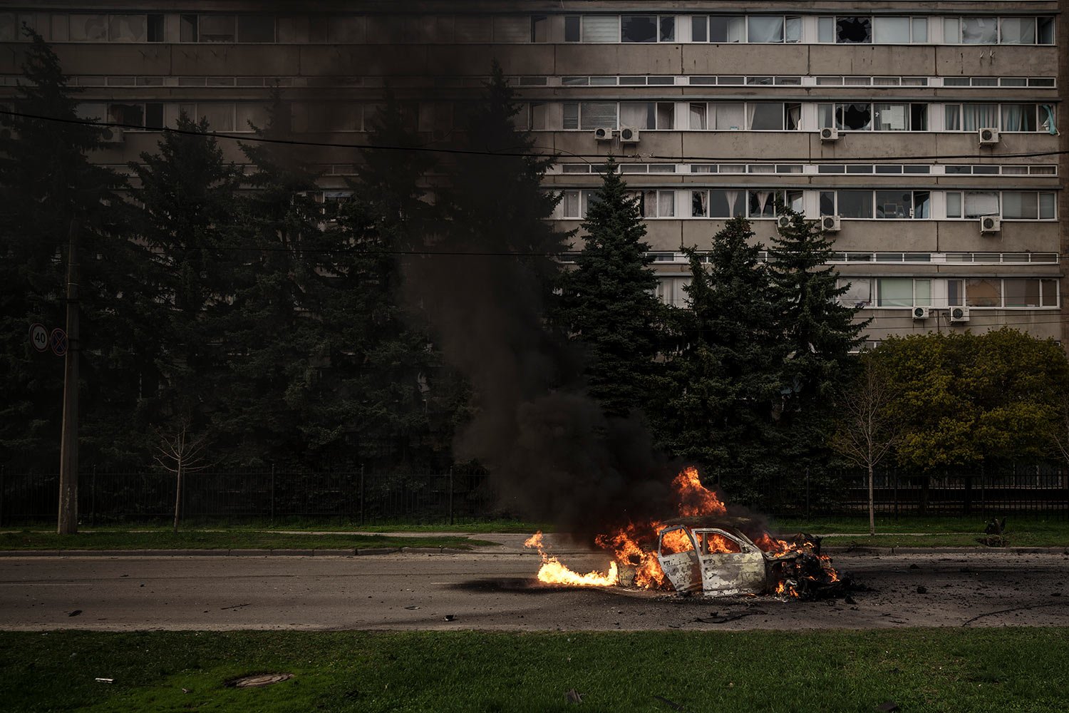  A car burns with two people inside, after a Russian bombardment in Kharkiv, Ukraine, Thursday, April 21, 2022. (AP Photo/Felipe Dana) 