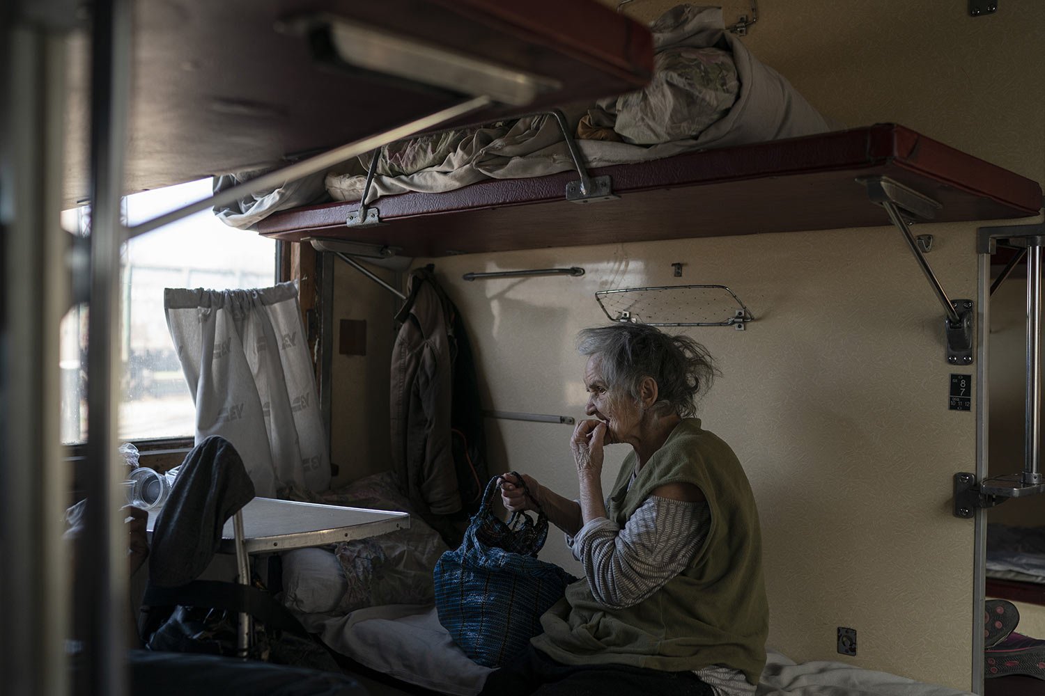  An elderly woman in a railway wagon at a train station in Pokrovsk, Ukraine, Monday, April 25, 2022, as she flees the war in Severodonetsk and nearby towns. Russia unleashed a string of attacks against Ukrainian rail and fuel installations Monday, s
