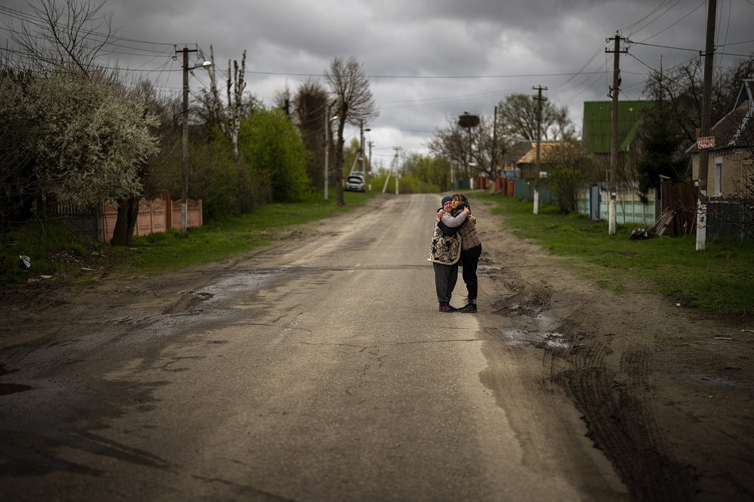  Tetyana Boikiv, 52, right, hugs her neighbor Svitlana Pryimachenko, 48, during the funeral of her husband Mykola Moroz, 47, in Ozera village near Bucha, Ukraine, Tuesday, April 26, 2022. Mykola was captured by Russian soldiers from his home in Ozera