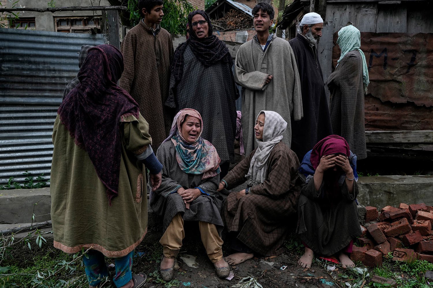  Members of a Kashmiri family mourn the loss after their house was damaged in a gun-battle between government forces and suspected rebels in Malwah village, north of Srinagar, Indian controlled Kashmir, Thursday, April 21, 2022.  (AP Photo/Mukhtar Kh