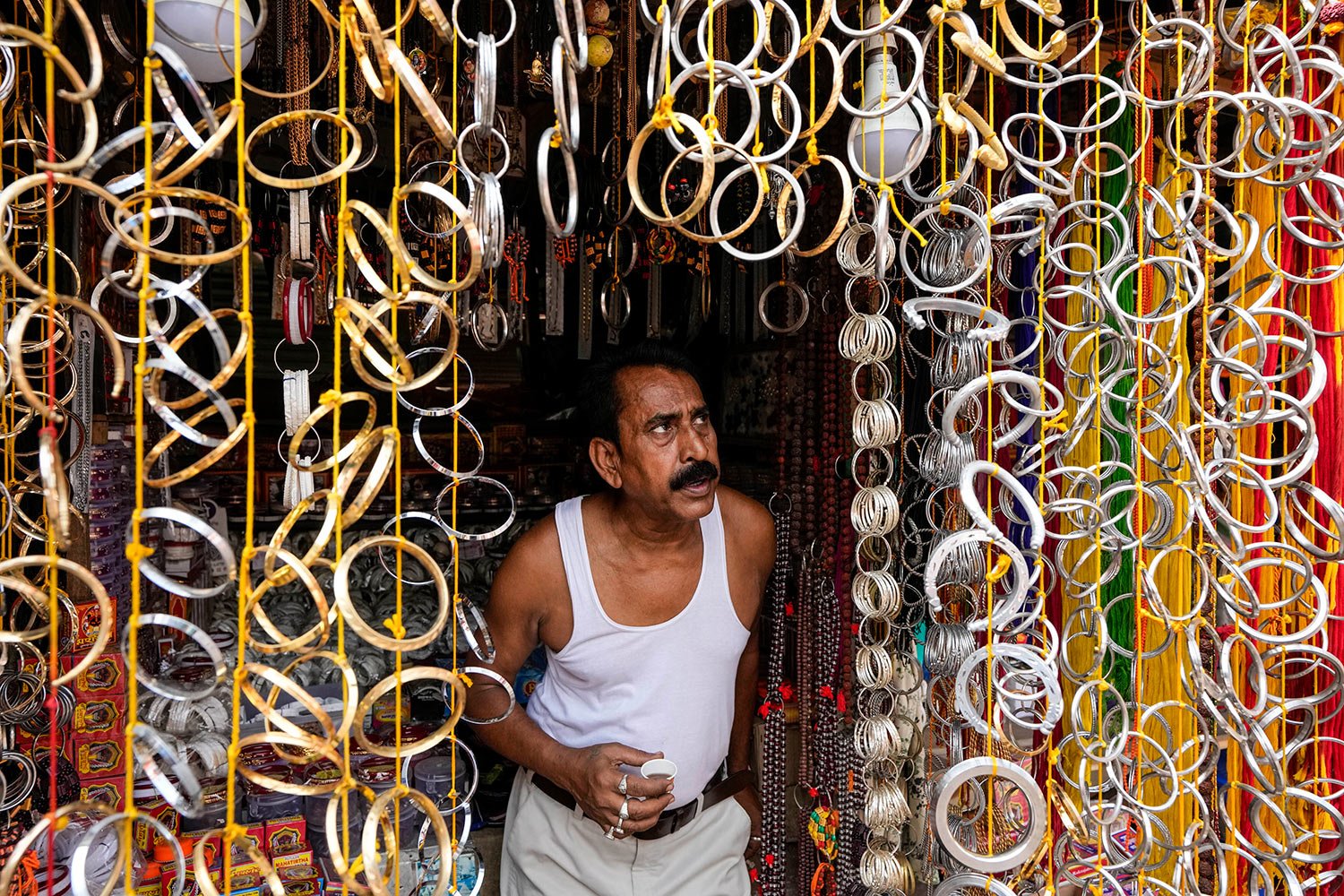  A shopkeeper waits for customers for bangles on sale at his shop on Bengali New Year's day in Kolkata, India, Friday, April 15, 2022. (AP Photo/Bikas Das) 