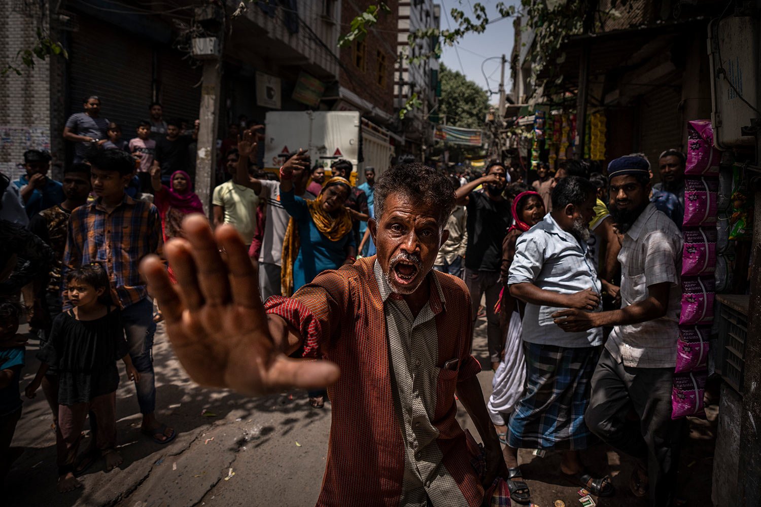  An agitated Muslim resident asks media to leave alleging them of distorting facts, during the demolition of Muslim-owned shops at the site of Saturday's communal violence, in New Delhi's northwest Jahangirpuri neighborhood, in New Delhi, India, Wedn