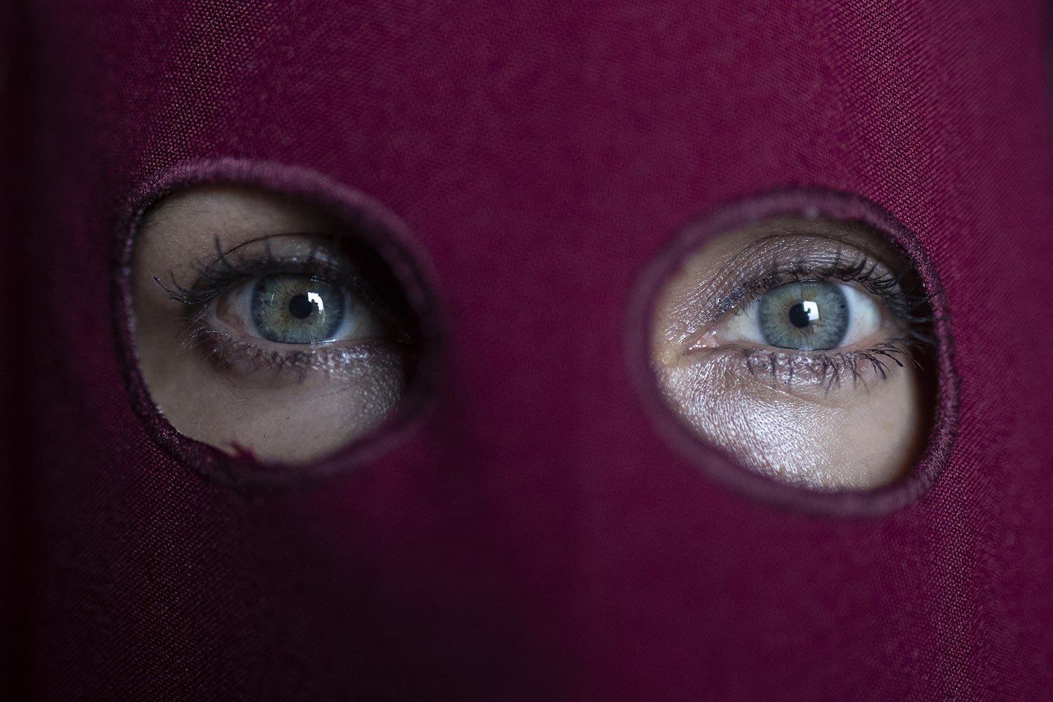  A member of the Nazarene brotherhood eyes the camera from behind her “capirote” head covering at a Good Friday procession in Zipaquira, Colombia, April 15, 2022. (AP Photo/Ivan Valencia) 