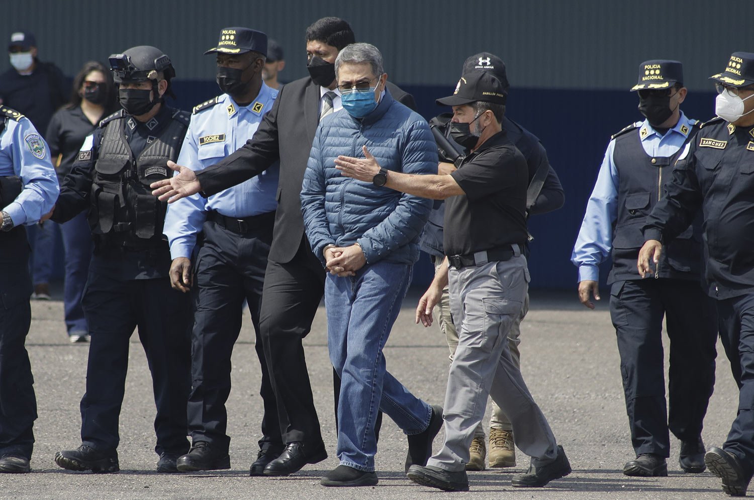  Former Honduran President Juan Orlando Hernandez is taken in handcuffs to an aircraft as he is extradited to the U.S. where he faces drug trafficking and weapons charges, at an Air Force base in Tegucigalpa, Honduras, April 21, 2022. (AP Photo/Elmer