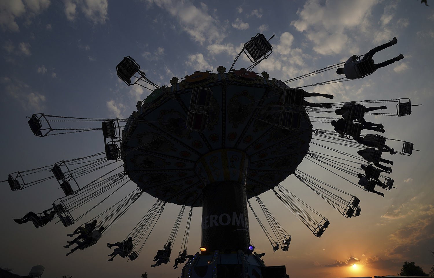  People ride a swing carousel at the Ceremonia music festival in Mexico City, April 2, 2022. (AP Photo/Fernando Llano) 