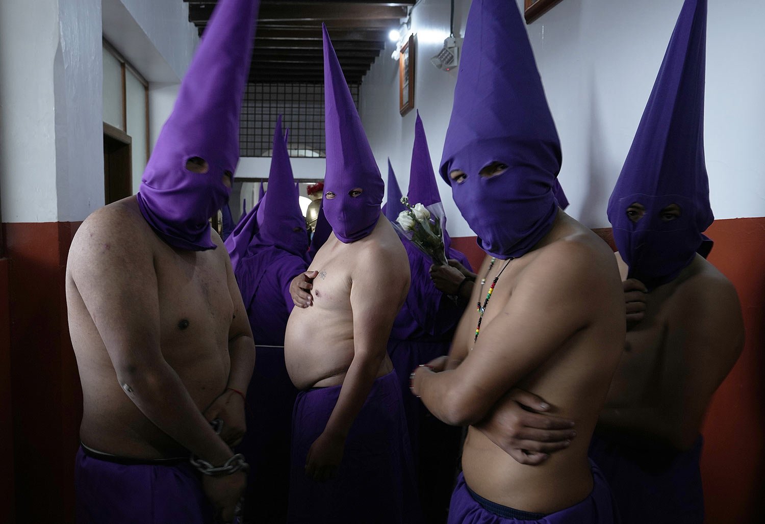  Hooded penitents known as "cucuruchos" pose for a photo in the San Francisco church as they wait for the start of the Jesus of Great Power procession in Quito, Ecuador, April 15, 2022. (AP Photo/Dolores Ochoa) 