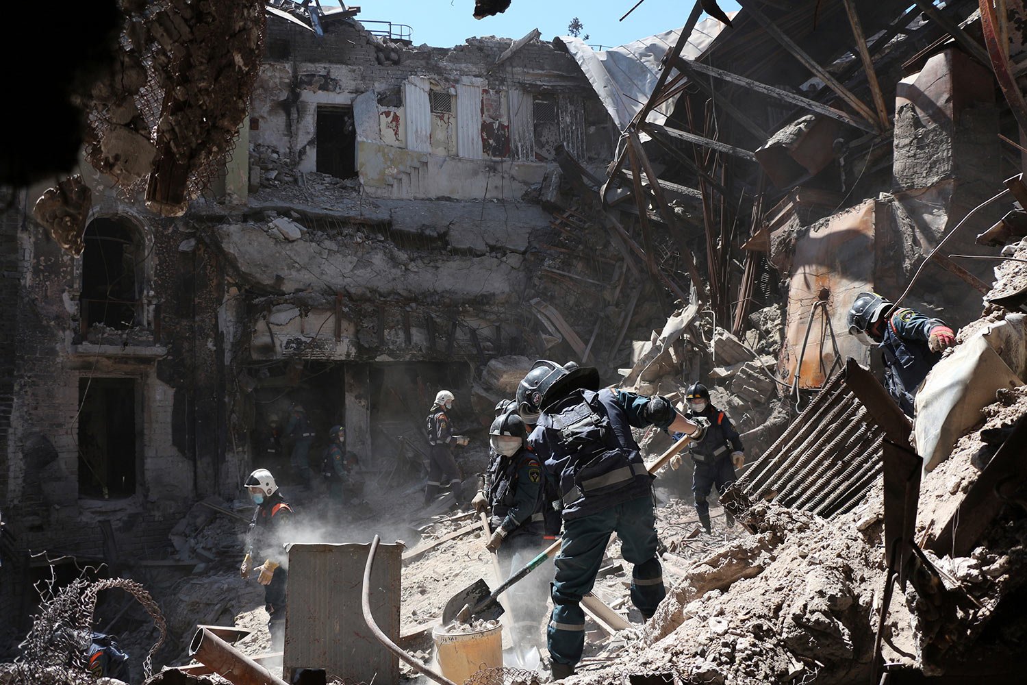  Donetsk People Republic Emergency Situations Ministry employees clear rubble at the side of the damaged Mariupol theater in Mariupol, in a territory under the government of the Donetsk People's Republic, eastern Ukraine, Thursday, May 12, 2022. (AP 