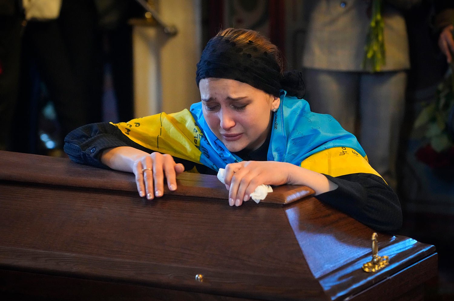  The widow cries at the coffin of volunteer soldier Oleksandr Makhov, 36 a well-known Ukrainian journalist, killed by the Russian troops, at St. Michael cathedral in Kyiv, Ukraine, Monday, May 9, 2022. (AP Photo/Efrem Lukatsky) 