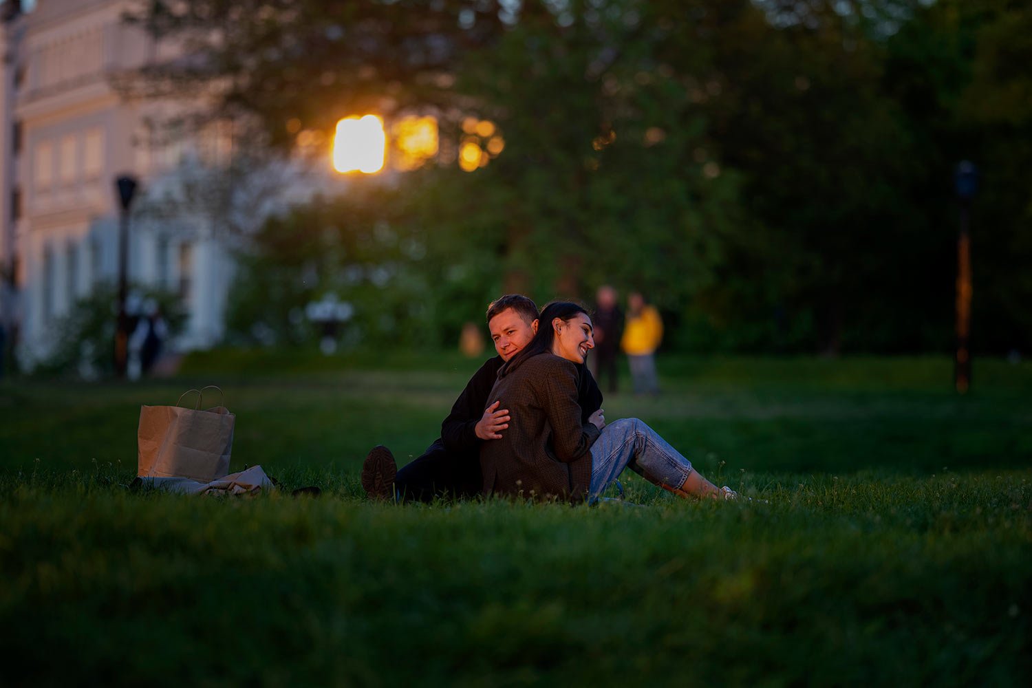  Stepan and Anastasia sit at a public park as the sun sets in Kyiv Ukraine on Tuesday, May 10, 2022. (AP Photo/Emilio Morenatti) 