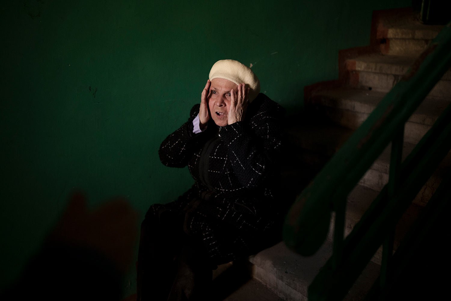  A woman reacts next to the body of a 15-year-old boy killed during a Russian attack in Kharkiv, Ukraine, Friday, April 15, 2022. (AP Photo/Felipe Dana)  