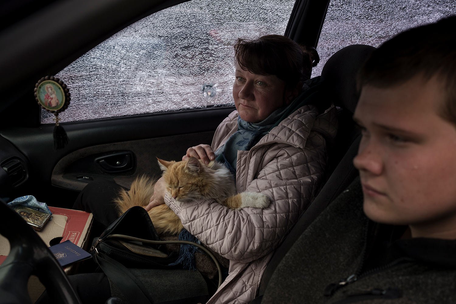  A family fleeing the village of Ruska Lozova arrive in their shrapnel-ridden car to a screening point in Kharkiv, Ukraine, Friday, April 29, 2022. (AP Photo/Felipe Dana)  