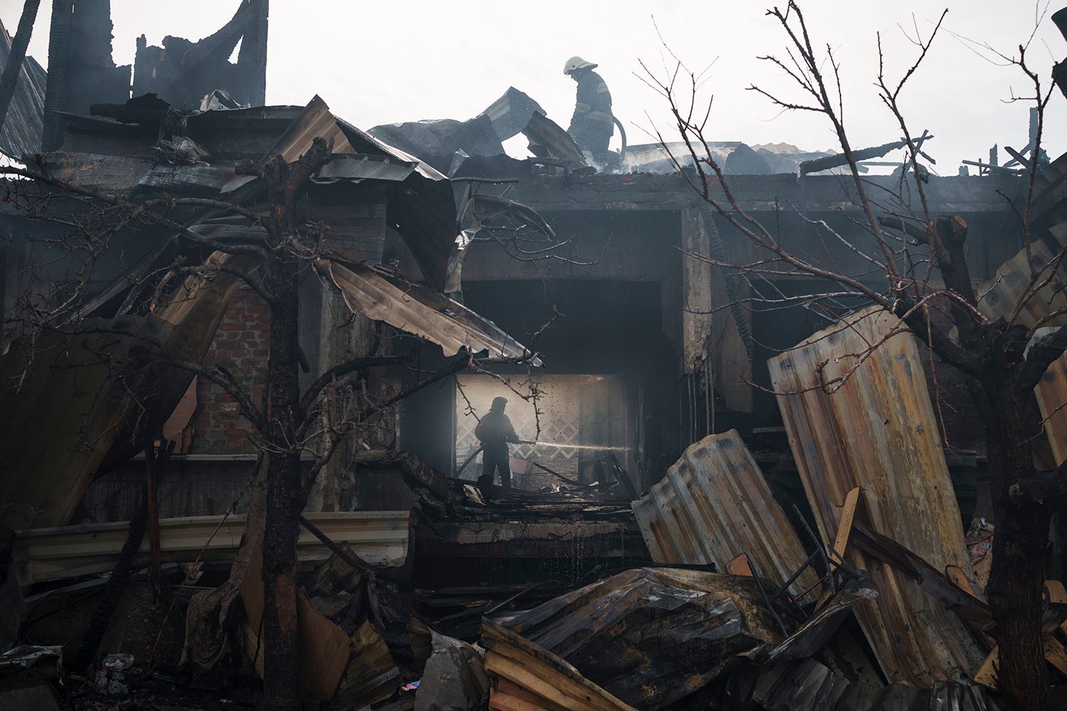  Firefighters work to extinguish a blaze at a house after a Russian attack in Kharkiv, Ukraine, Monday, April 11, 2022. (AP Photo/Felipe Dana)  