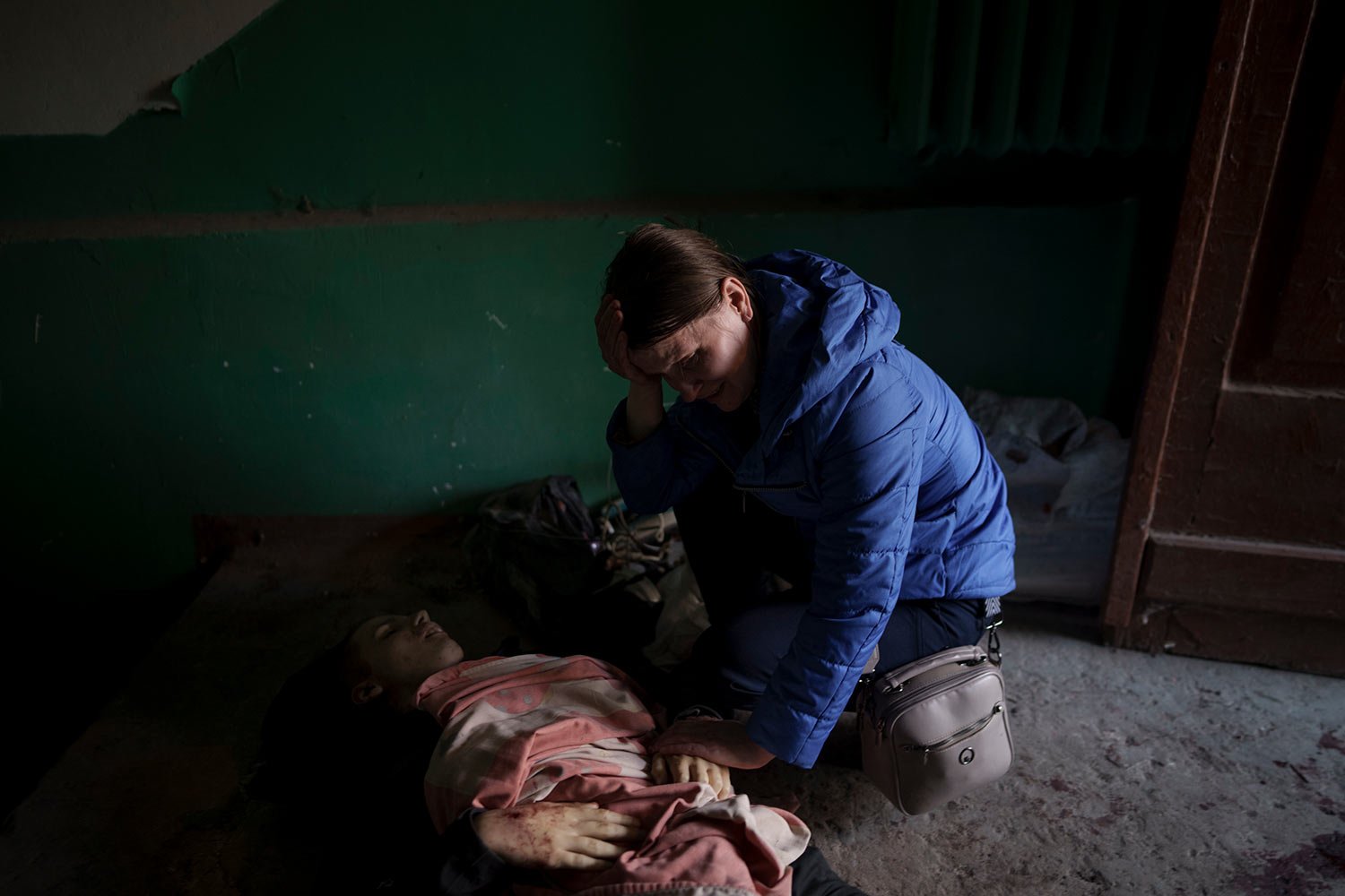  Nina Shevchenko mourns next to the body of her 15-year-old son Artem Shevchenko, who was killed in a Russian attack in Kharkiv, Ukraine, Friday, April 15, 2022. (AP Photo/Felipe Dana)  
