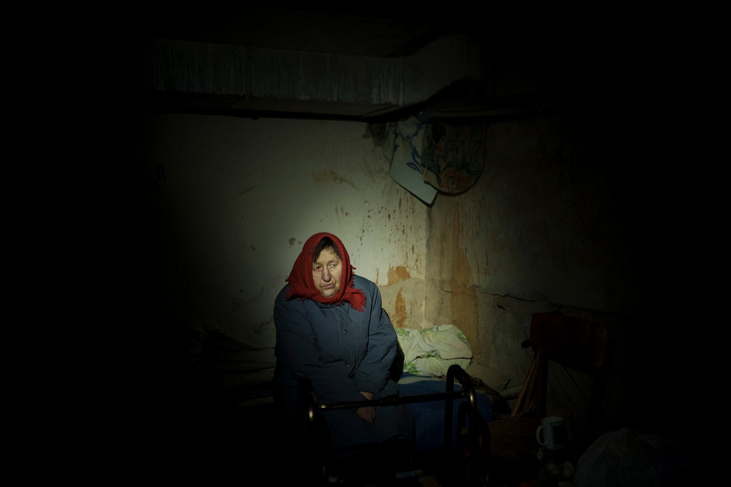  An elderly woman hides in a basement for shelter, with no electricity, in Irpin, outskirts of Kyiv, Ukraine, Sunday, March 13, 2022. (AP Photo/Felipe Dana)  