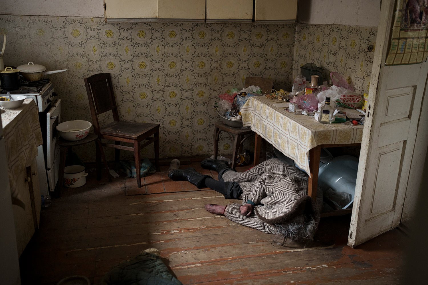  The body of an elderly woman lies inside a house in Bucha, outskirts of Kyiv, Ukraine, Tuesday, April 5, 2022. (AP Photo/Felipe Dana)  