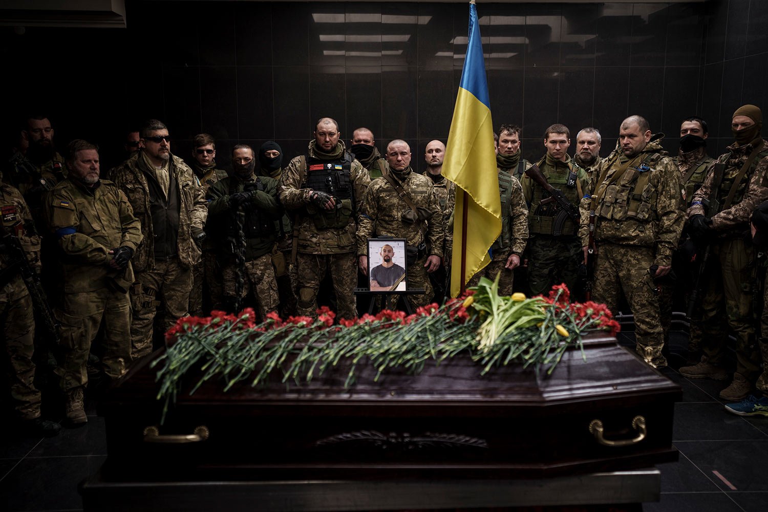  Ukrainian servicemen attend the funeral ceremony of marine Alexandr Khovtun, in Kyiv, Ukraine, Sunday, March 20, 2022. Khovtun died in combat in the town of Huta-Mezhyhirska, north of Kyiv. (AP Photo/Felipe Dana)  