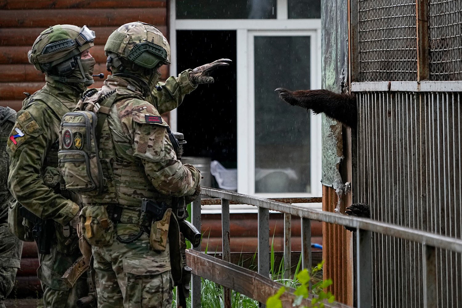 Russian soldiers play with a bear at the zoo in Mariupol, in territory under the government of the Donetsk People's Republic, eastern Ukraine, Wednesday, May 18, 2022. This photo was taken during a trip organized by the Russian Ministry of Defense. 