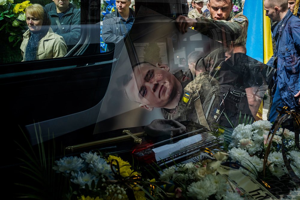  Relatives and friends attend a funeral in Lviv, Ukraine, Saturday, May 14, 2022, of Melnyk Andriy, 23, a Ukrainian military serviceman who was killed in Kharkiv province. (AP Photo/Emilio Morenatti) 