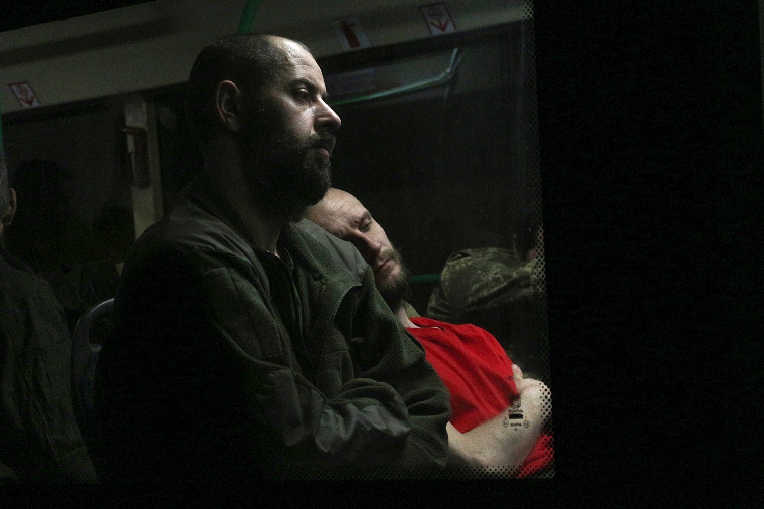  Ukrainian servicemen sit in a bus after they were evacuated from the besieged Mariupol's Azovstal steel plant, near a prison in Olyonivka, in territory under the government of the Donetsk People's Republic, eastern Ukraine, Tuesday, May 17, 2022. (A