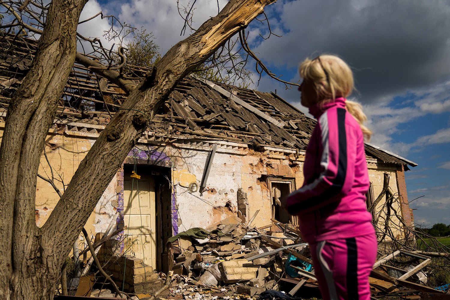  Iryna Martsyniuk, 50, stands next to her heavily damaged house after a Russian bombing in Velyka Kostromka village, Ukraine, Thursday, May 19, 2022. Martsyniuk and her three young children were at home when the attack occurred in the village, a few 