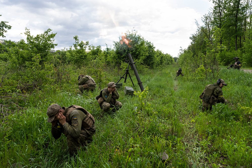  Ukrainian servicemen accompanied by members of the foreign legion fire mortars at Russian positions in the eastern region of Kharkiv, Ukraine, Tuesday, May 17, 2022. (AP Photo/Bernat Armangue) 