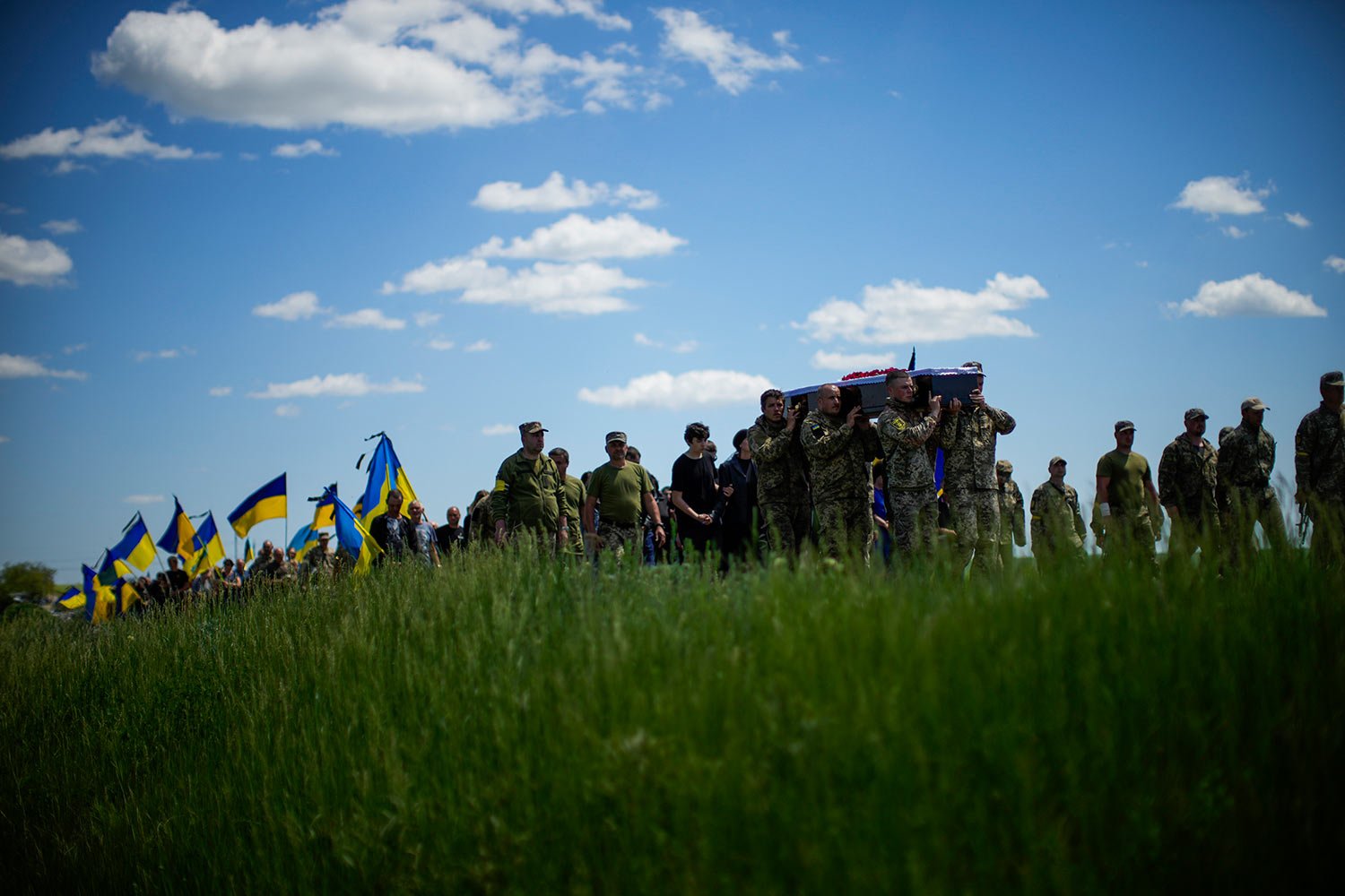  Ukrainian soldiers carry the coffin of Volodymyr Losev, 38, during his funeral in Zorya Truda, Odesa region, Ukraine, Monday, May 16, 2022. Volodymyr Losev, a Ukrainian volunteer soldier, was killed May 7 when the military vehicle he was driving ran
