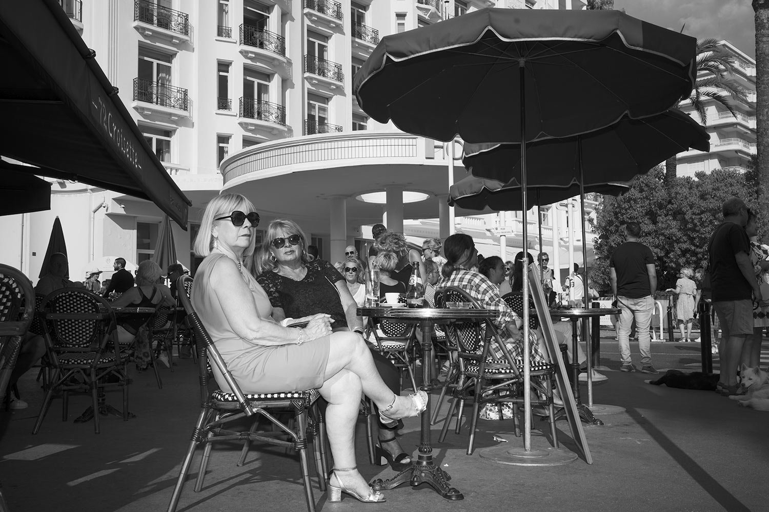  People sit at a cafe on the Croisette during the 75th international film festival, Cannes, southern France, Tuesday, May 24, 2022. (AP Photo/Petros Giannakouris) 