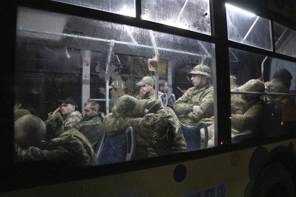  Ukrainian servicemen sit in a bus after leaving Mariupol's besieged Azovstal steel plant near a penal colony in Olyonivka in territory under the Pro-Russian government of the Donetsk People's Republic, eastern Ukraine, Friday, May 20, 2022. (AP Phot