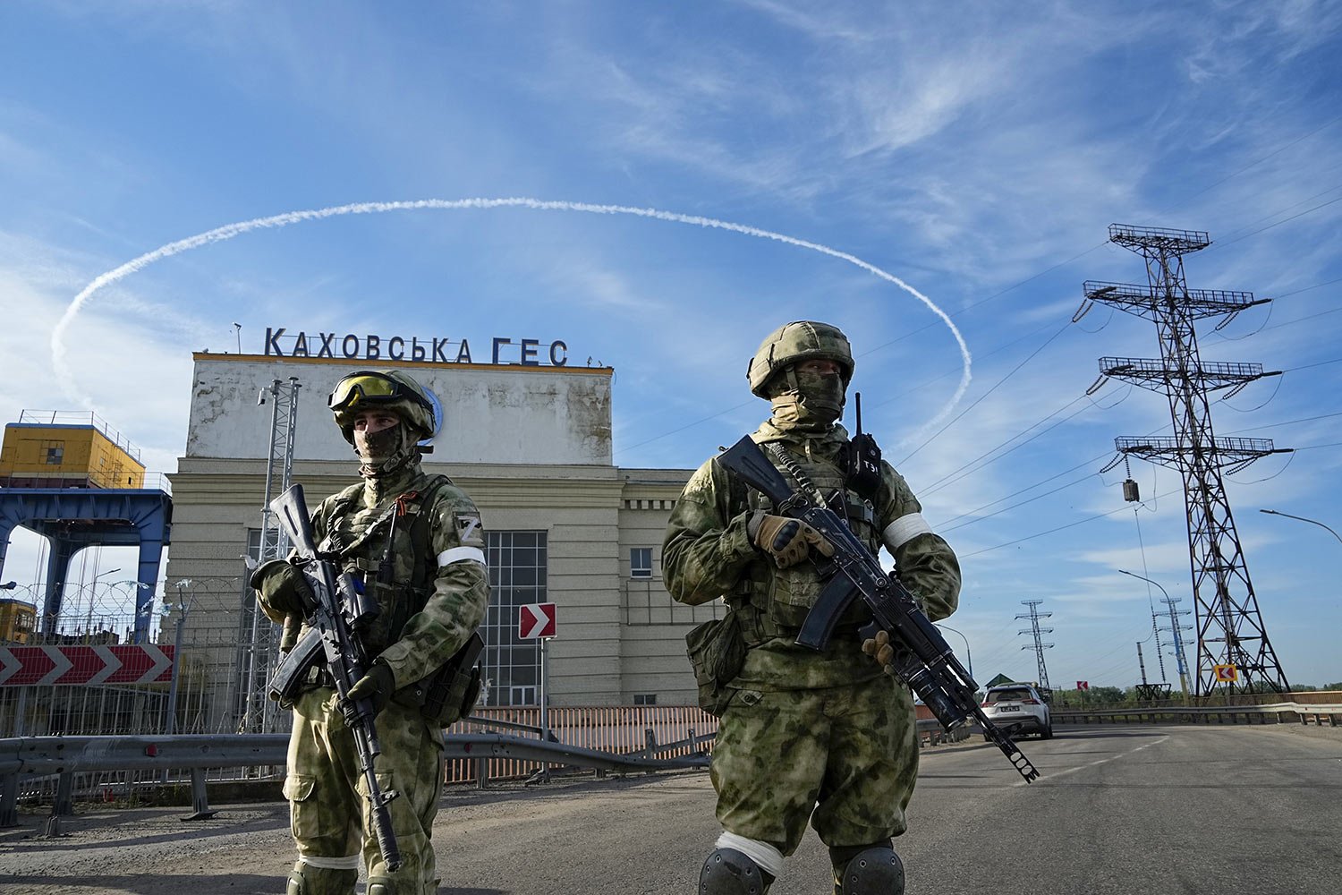  Russian troops guard an entrance of the Kakhovka Hydroelectric Station, a run-of-the-river power plant on the Dnieper River in Kherson region, southern Ukraine, Friday, May 20, 2022, during a trip organized by the Russian Ministry of Defense. The Kh