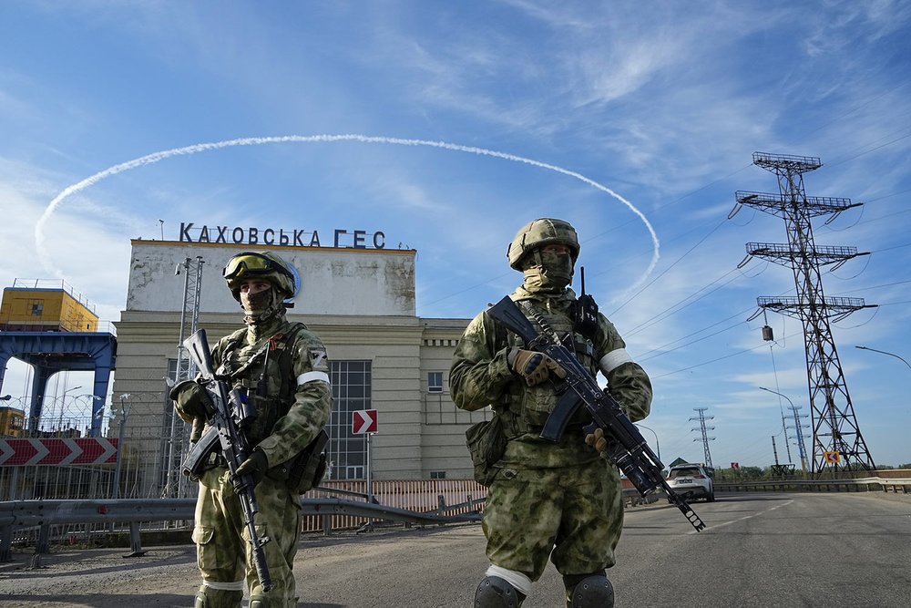  Russian troops guard an entrance of the Kakhovka Hydroelectric Station, a run-of-the-river power plant on the Dnieper River in Kherson region, southern Ukraine, Friday, May 20, 2022, during a trip organized by the Russian Ministry of Defense. The Kh
