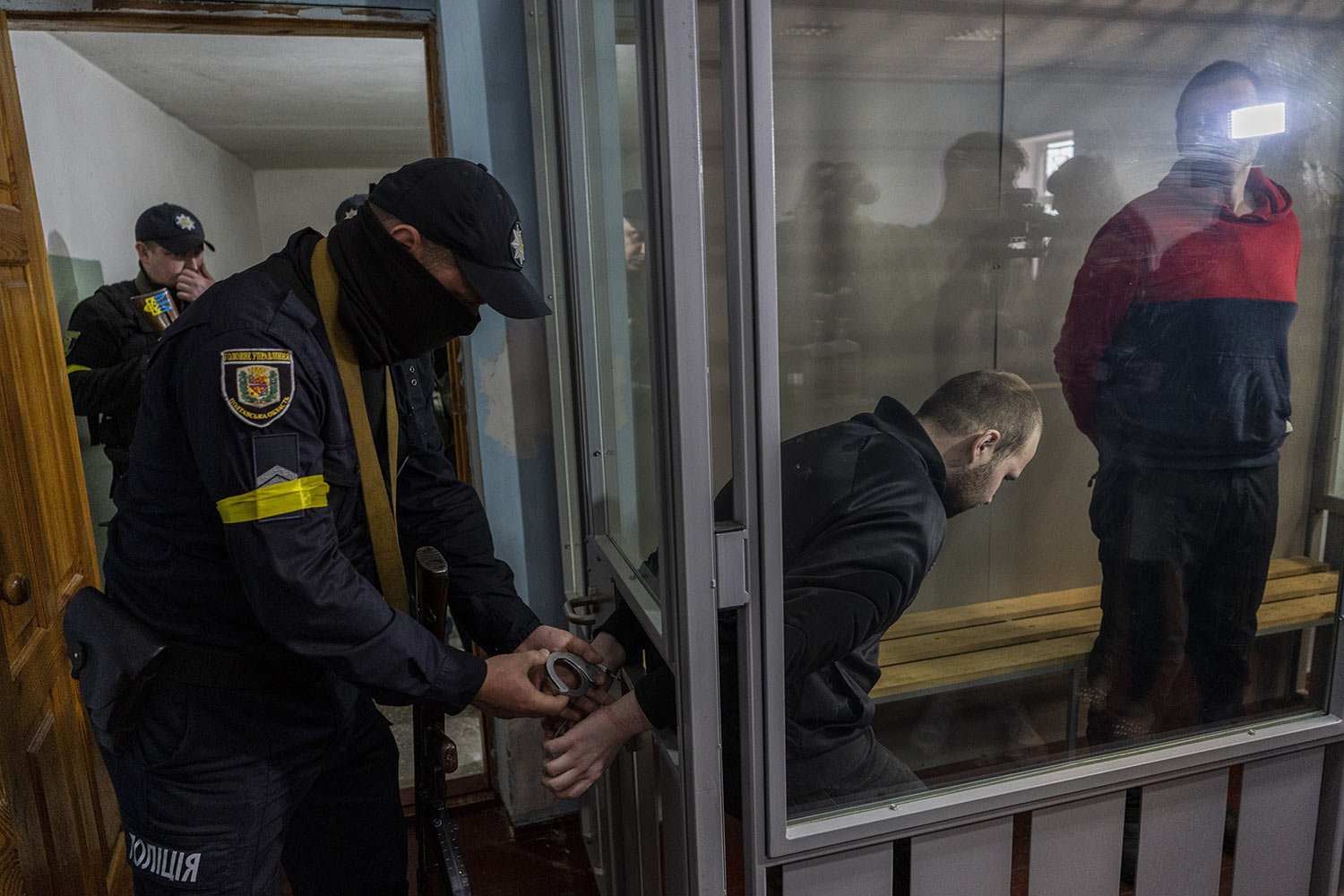  Captured Russian soldiers Alexander Alexeevich Ivanov and Alexander Vladimirovich Bobykin, right, leave the courtroom after their trial, accused of war crimes in Ukraine, in Kotelva, northeastern Ukraine, Thursday, May 26, 2022. (AP Photo/Bernat Arm