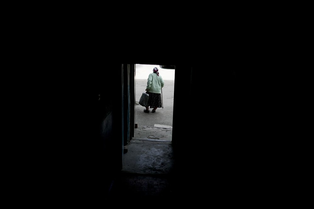  Dina walks out of her home ruined by shelling in Horenka on the the outskirts Kyiv, Ukraine, Wednesday, May 25, 2022. (AP Photo/Natacha Pisarenko) 