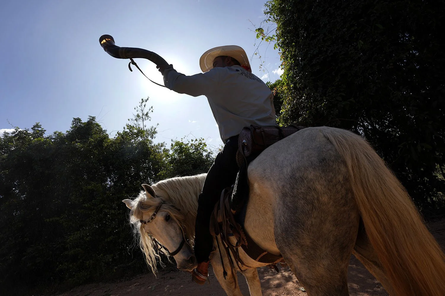  A rider plays an ox-horn musical instrument called a Berrante during a parade culminating the Feast of the Divine, in Pirenopolis, Goias state, Brazil, May 28, 2022. (AP Photo/Eraldo Peres) 