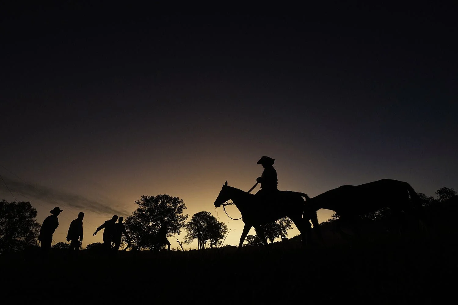  A rider is silhouetted against the horizon during the culmination of the Feast of the Divine, in Pirenopolis, Goias state, Brazil, May 28, 2022. (AP Photo/Eraldo Peres) 